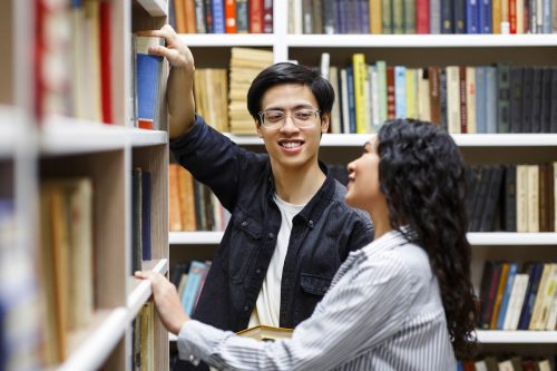 man flirting with woman library
